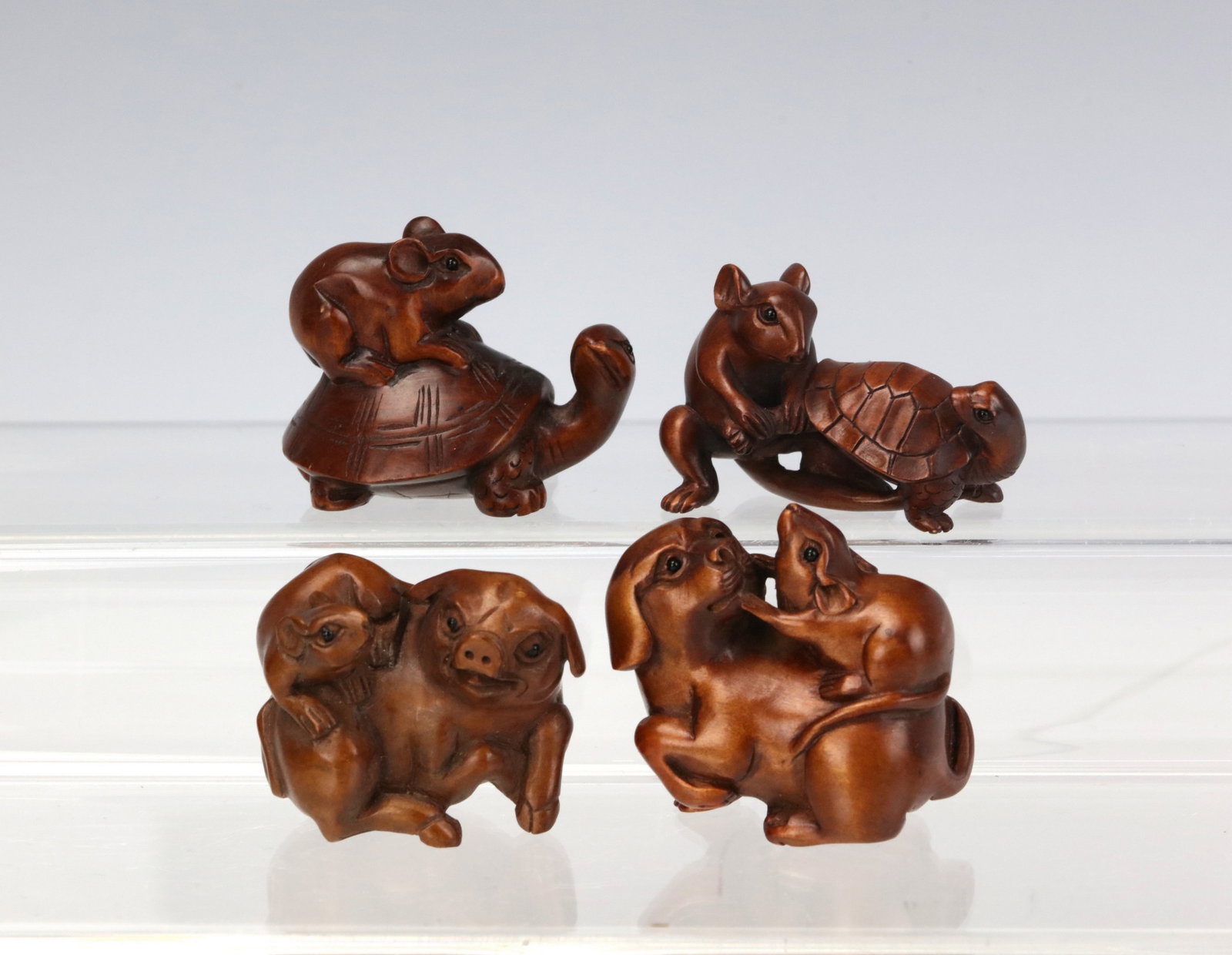 Four Carved Wooden Animal Figurines Mouse Squirrel Pig and Dog Group: Four Carved Wooden Animal Figurines Mouse Squirrel Pig and Dog Group. H 4.5 cm(1.8 in.). Preview from Aug 24th to 28th from 1:00 PM TO 5:00 PM Eastern Time, Location: 15229 Display Court, Rockville, M