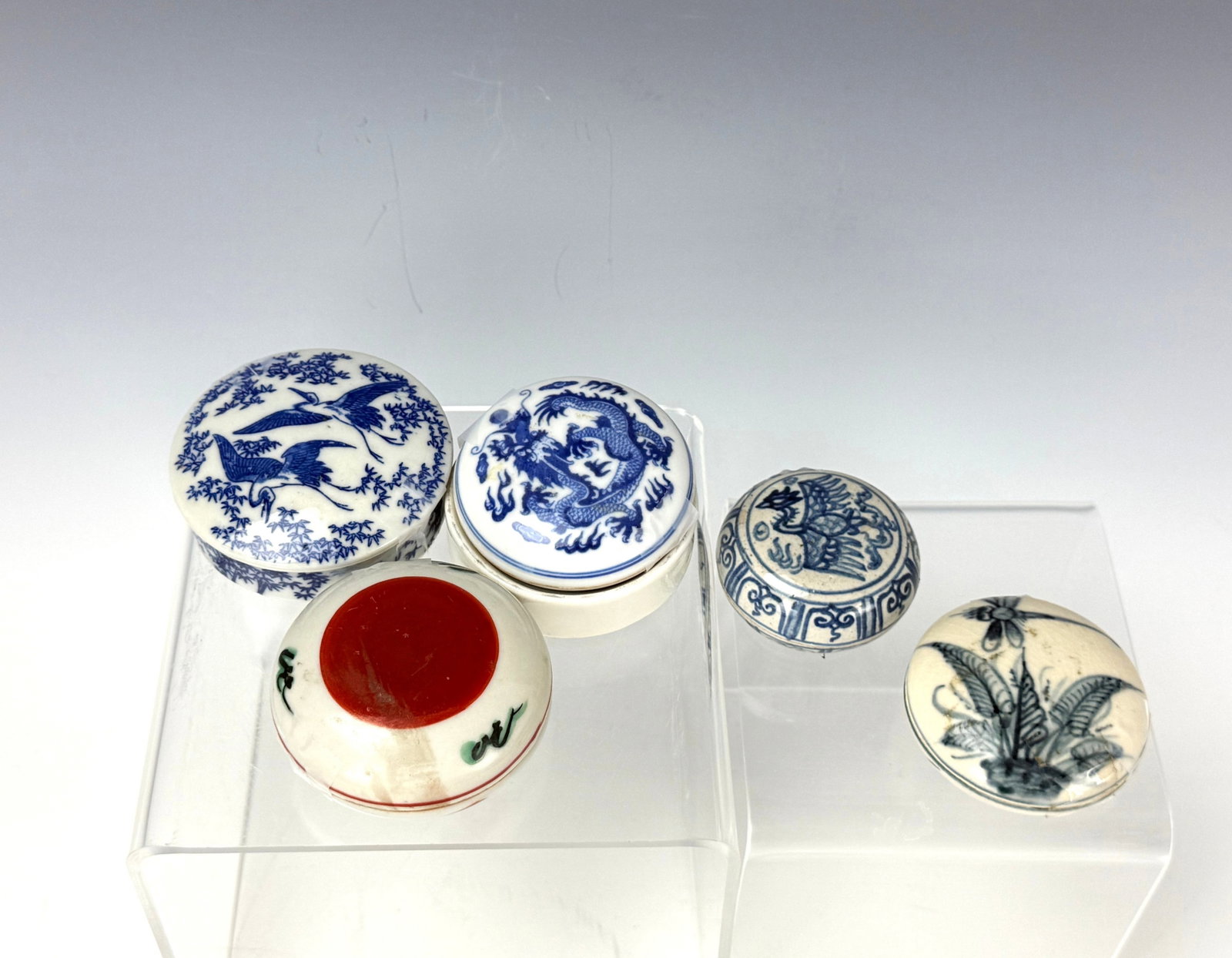 Five Small Porcelain Covered Boxes: Five Small Porcelain Covered Boxes Blue and White and Polychrome Designs with Dragons, Birds, and Floral Motifs. D 7 cm(2.7 in.). Preview from Aug 24th to 28th from 1:00 PM TO 5:00 PM Eastern Time, Lo