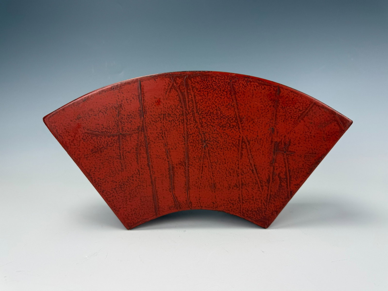 A Vintage Chinese Red Lacquer Fan Shaped Box: Red Lacquer Fan Shaped Box Painted Birds, Bamboo, and Floral Motifs with Black Interior. W 33 cm(13 in.) x H 15 cm(5.9 in.). Preview from Aug 24th to 28th from 1:00 PM TO 5:00 PM Eastern Time,