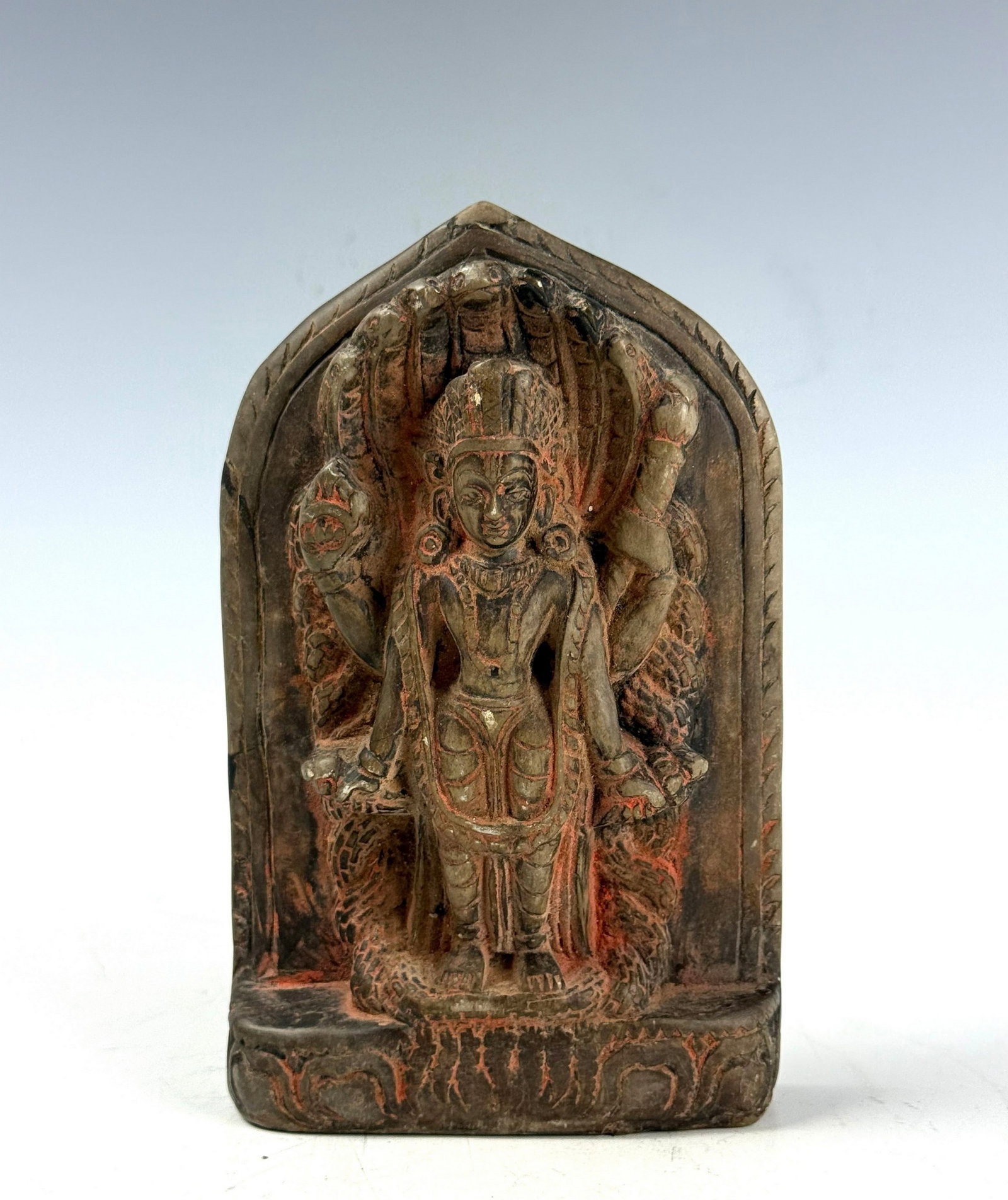 A Carved Stone Multi Armed Deity Figure: Carved Stone Multi Armed Deity Figure Arched Niche Panel with Jewelry, Headdress, and Traces of Pigment. H 15.4 cm(6.1 in.) x W 9.3 cm(3.7 in.). Preview from Aug 24th to 28th from 1:00 PM TO 5:00 PM
