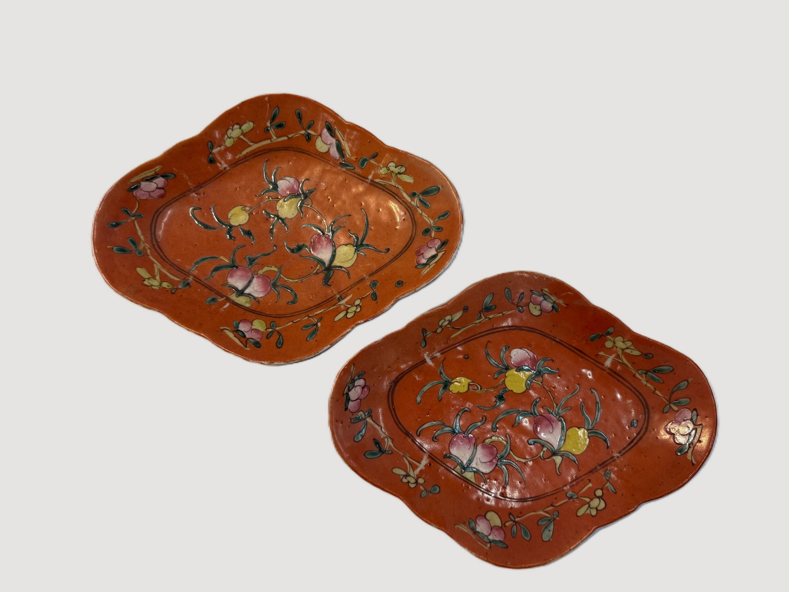 Two Late Qing Dynasty Coral Ground Famille Rose Porcelain Footed Dishes: Two Late Qing Dynasty Coral Ground Famille Rose Porcelain Footed Dishes. W 25.9 cm(10.2 in.) x H 4.5 cm(1.8 in.). Preview from Aug 24th to 28th from 1:00 PM TO 5:00 PM Eastern Time, Location: 15229 Di
