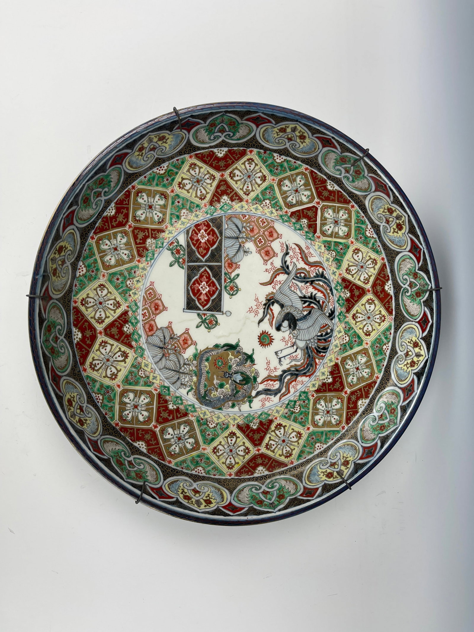 Large Japanese Antique Imari Porcelain Charger with Phoenix and Floral Medallion: Large Japanese Antique Imari Porcelain Charger with Phoenix and Floral Medallion. D 47 cm (18.5 in.) x H 8.5 cm (3.3 in.). Preview from Aug 24th to 28th from 1:00 PM TO 5:00 PM Eastern Time, Location: