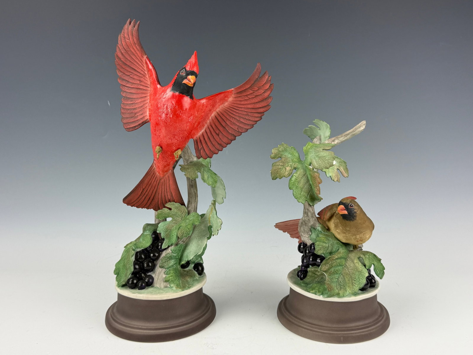 Pair of Porcelain Cardinal Figurines Male and Female on Branches Limited Edition: Pair of Porcelain Cardinal Figurines Male and Female on Branches Limited Edition Cardinals, Made in USA. H 37 cm(14.6 in.) x W 14.2 cm(5.6 in.). Preview from Aug 24th to 28th from 1:00 PM TO 5:00 PM E