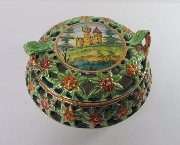 Capodifiori Porcelain Trinket Box: DESCRIPTION: A Capodifiori porcelain trinket box. Features a flattened, rotund shaped with ornate reticulations embellished with an array of rosettes enveloped by winding foliage and verdant motifs. F