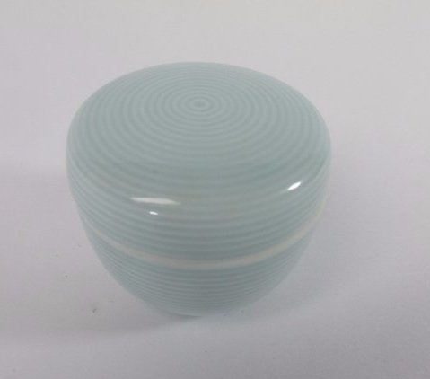 Noritake Porcelain Trinket Box: DESCRIPTION: A Noritake porcelain trinket box. Features a contemporary motif with a celadon hued concentric circular design. Finished with an overall glossed glaze and marked on the bottom:"Noritake J