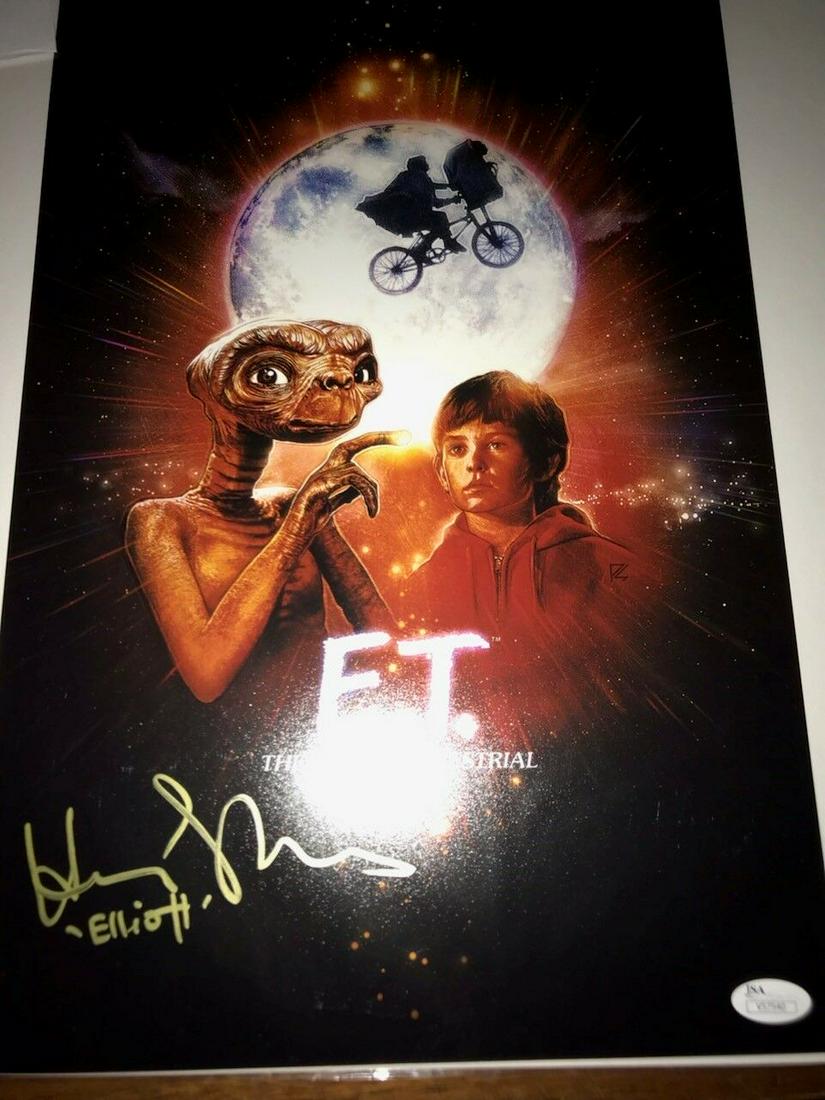 E.T. 11x17 poster signed by Henry Thomas inscribed: E.T. 11x17 poster signed by Henry Thomas inscribed "Elliott" JSA Auth