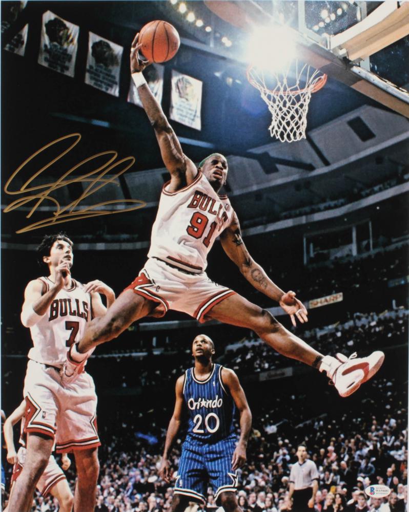 Dennis Rodman Signed Bulls 16x20 Photo (Beckett COA): Photo measures 16" x 20" in size and has been hand-signed in gold paint pen by Dennis Rodman (HOF).The lot / autograph(s) includes an official Beckett Authentication Services serially-numbered hologra