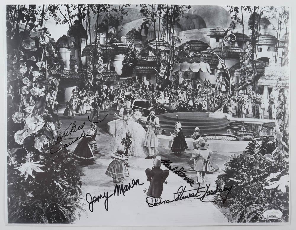 "The Wizard of Oz" 11x14.5 Photo Cast-Signed by (4): "The Wizard of Oz" 11x14.5 Photo Cast-Signed by (4) with Karl Slover, Mickey Carroll, Jerry Maren & Donna Stewart-Hardway (JSA COA)