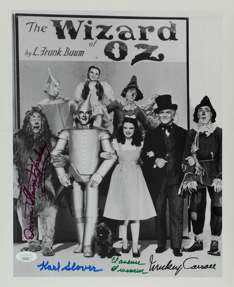 "The Wizard Of Oz" 11x14 Photo Cast-Signed by (4) with: Photo measures approximately 11" x 14" in size and has been hand-signed by (4) including Mickey Carroll (D. 2009), Jerry Maren (D.2018), Clarence Swensen (D. 2009), Karl Slover (D. 2011).The lot / aut