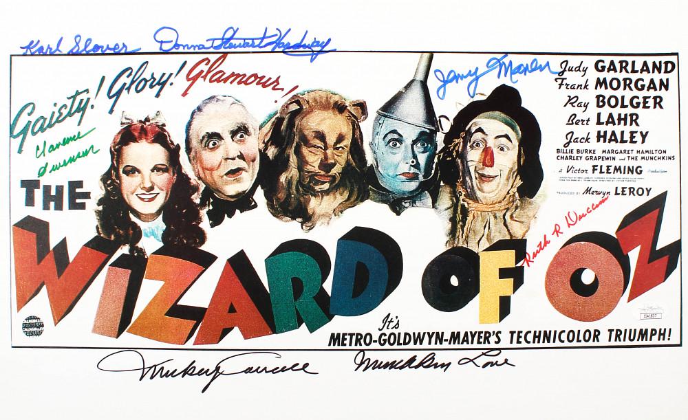 "The Wizard Of Oz" 11x17 Photo Cast-Signed by (6) with: Photo measures 11" x 17" in size and has been hand-signed by (6) including Mickey Carroll (D. 2009), Jerry Maren (D. 2018), Donna Stewart-Hardaway (D. 2008), Karl Slover (D. 2011), Clarence Swensen (D