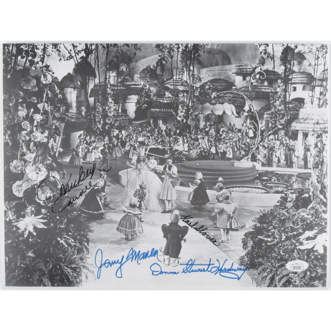 "The Wizard of Oz" 11x14 Photo Cast-Signed by (4) with: Photo measures 11" x 14" in size and has been hand-signed by Karl Slover (D. 2011), Mickey Carroll (D. 2009), Jerry Maren (D. 2018), and Donna Stewart-Hardway (D. 2008).The lot / autograph(s) includes