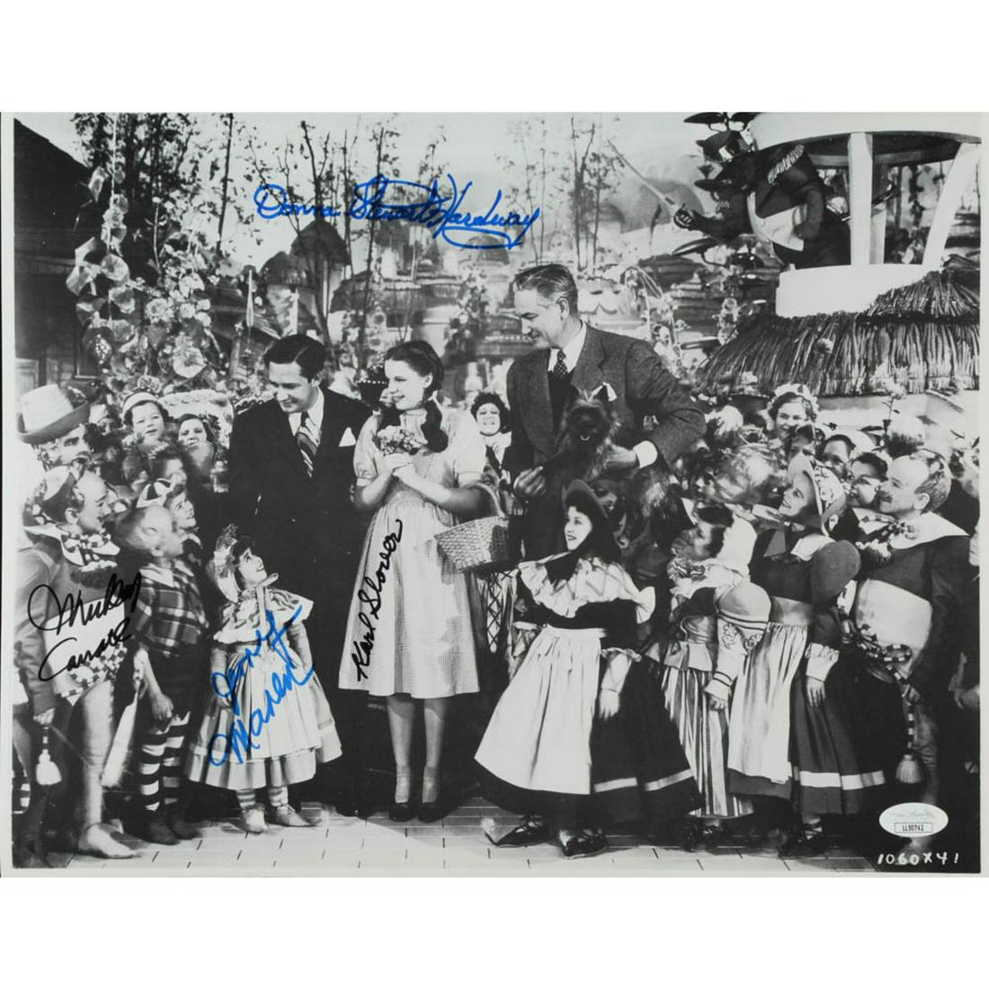 "The Wizard of Oz" 11.5x14.5 Photo Cast-Signed by (4): Photo measures 11.5" x 14.5" in size and has been hand-signed by Karl Slover (D. 2011), Mickey Carroll (D. 2009), Jerry Maren (D. 2018), and Donna Stewart-Hardway (D. 2008).The lot / autograph(s) incl