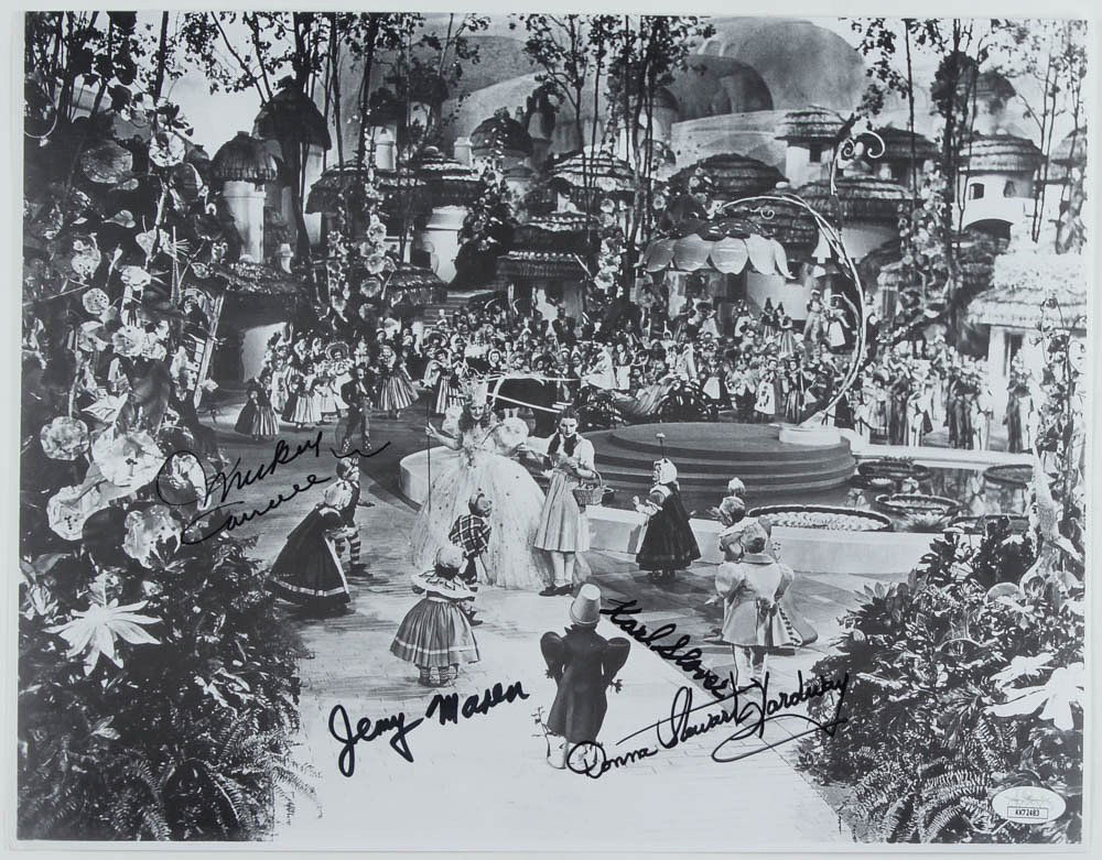 "The Wizard of Oz" 11x14.5 Photo Signed by (4) with: Photo measures approximately 11" x 14.5" in size and has been hand-signed and inscribed by (4) including Mickey Carroll (D. 2009), Jerry Maren (D. 2018), Donna Stewart-Hardaway (D. 2008), and Karl Slo
