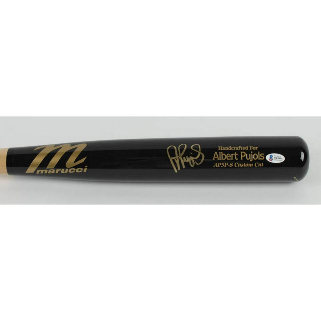 Albert Pujols Signed Marucci Player Model Baseball Bat: Marucci player model baseball bat. Hand-signed by Albert Pujols (Los Angeles Angels). The lot / autograph(s) includes an official Beckett Authentication Services serially-numbered hologram and matchin