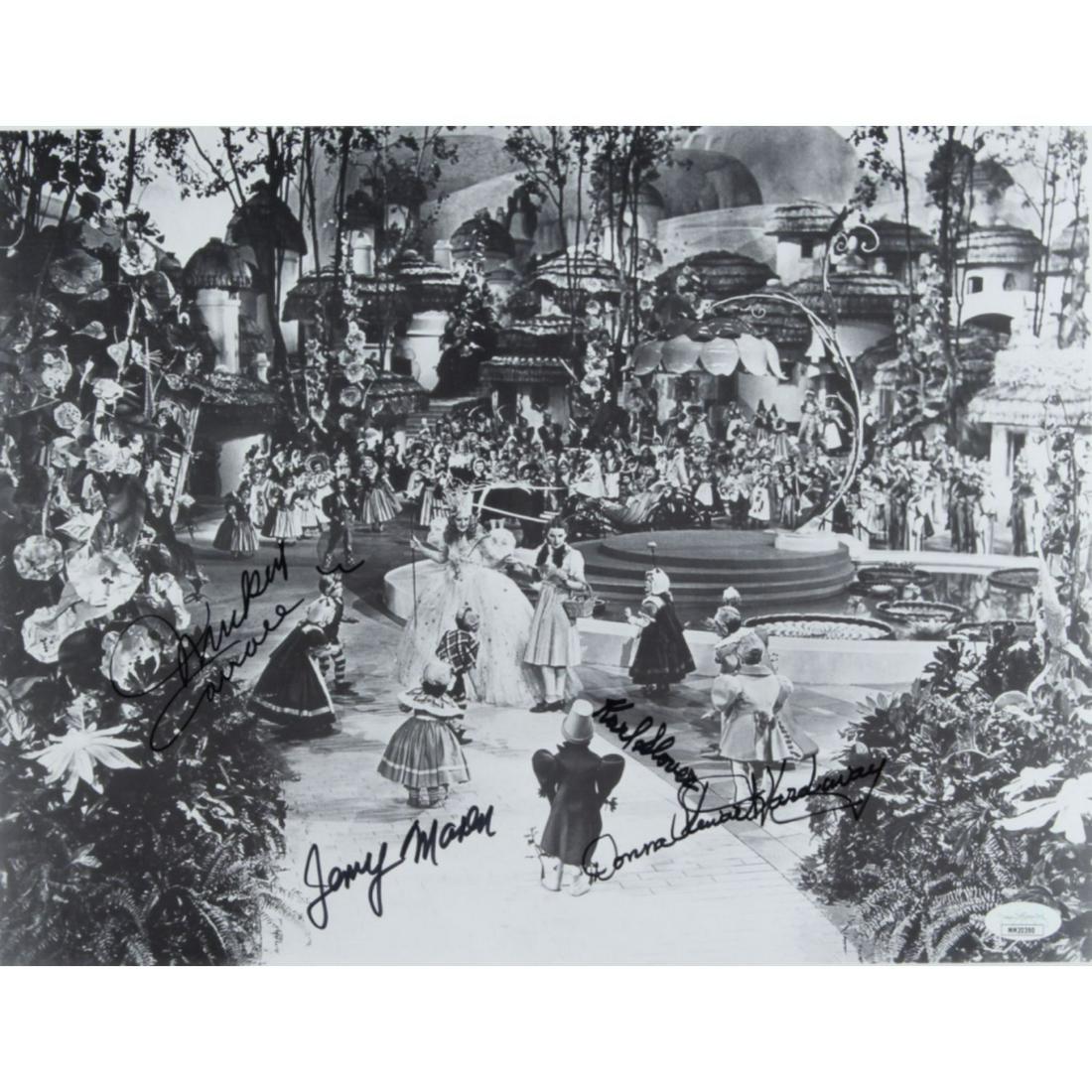 "The Wizard of Oz" 11x14 Photo Signed by (4) with: "The Wizard of Oz" 11x14 Photo Signed by (4) with Mickey Carroll, Jerry Maren, Karl Slover & Donna Stewart-Hardway (JSA COA)