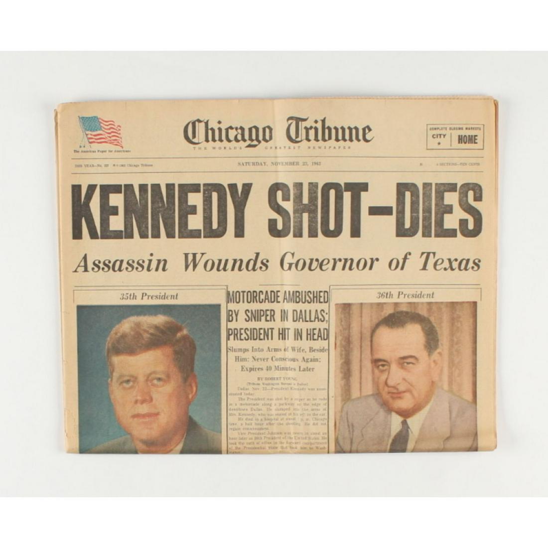 Original November 23rd, 1963 Chicago Tribune Newspaper: Original November 23rd, 1963 Chicago Tribune newspaper featuring headlines covering covering the assassination of then president Kennedy. Please note, the paper shows signs of wear. See photos for det