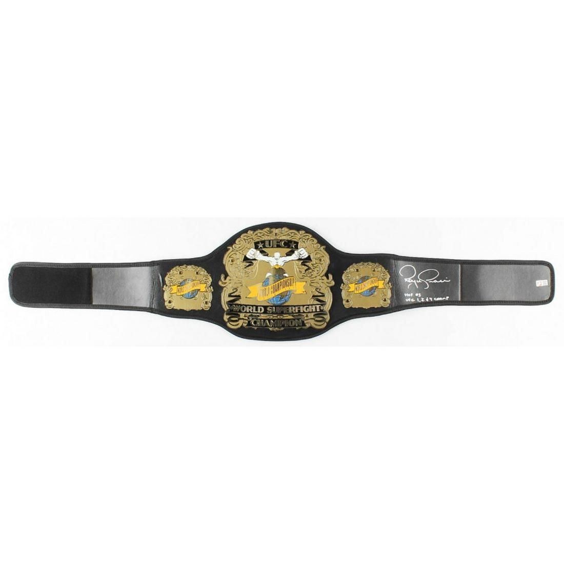 Royce Gracie Signed Full-Size UFC #1 Championship Belt Inscribed "HOF 03" & "UFC 1, 2, & 4 Champ": This full-size high-quality belt features a faux leather adjustable belt along with metal plates.The belt is hand-signed and inscribed "HOF 2003" and "UFC 1, 2, & 4 Champ" by UFC legend, Royce Gracie.