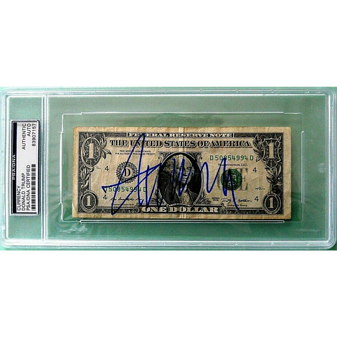 DONALD TRUMP SIGNED ONE DOLLAR BILL (PSA SLABBED): DONALD TRUMP SIGNED ONE DOLLAR BILL (PSA SLABBED)