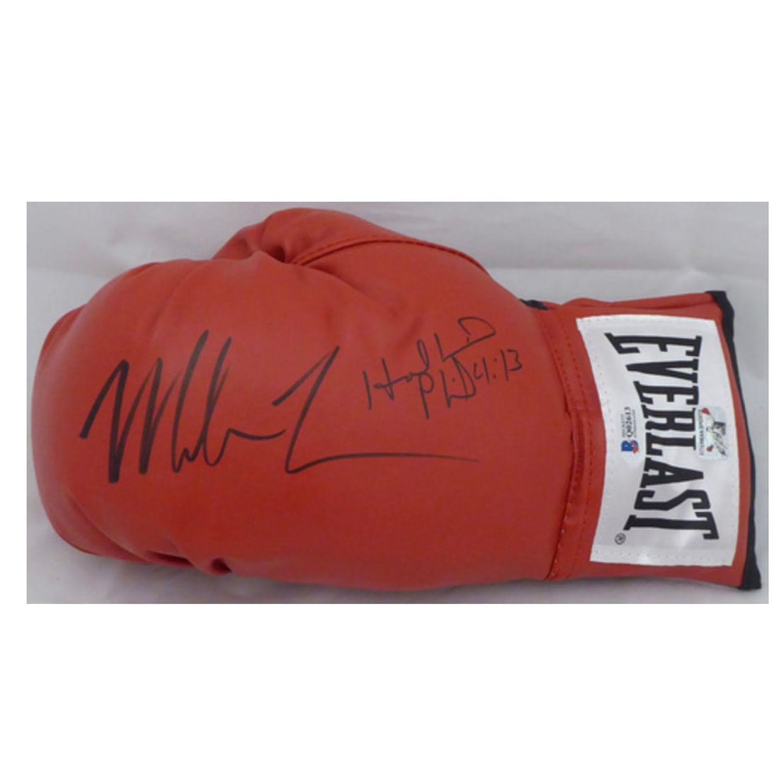 Mike Tyson & Evander Holyfield Autographed Red Everlast Boxing Glove LH Signed In Black Beckett BAS: This is a Red Everlast Boxing Glove that has been hand signed by Mike Tyson & Evander Holyfield. This one is left handed. It has been authenticated by Beckett (BAS) and has the official tamper-proof s