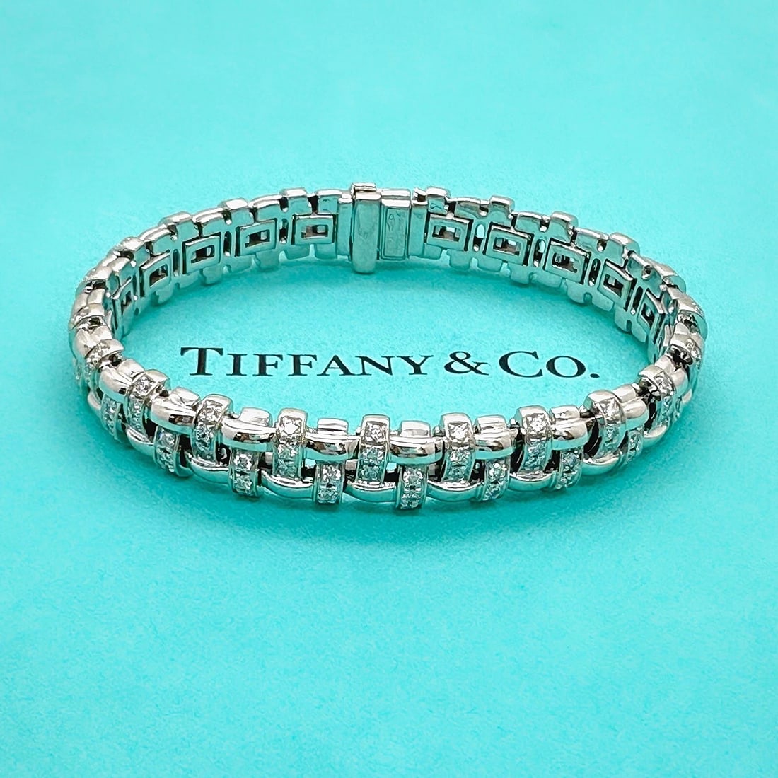 Tiffany & Co Vannerie Basket Weave Diamond Bracelet in 18kt White Gold: Condition: Pre-owned - Good,Closure: Hinged,Signed: Yes,Color: White,Main Stone Color: White,Metal: White Gold,Item Length: 7 in,Main Stone: Diamond,Brand: Tiffany & Co.,Main Stone Treatment: Not Enha
