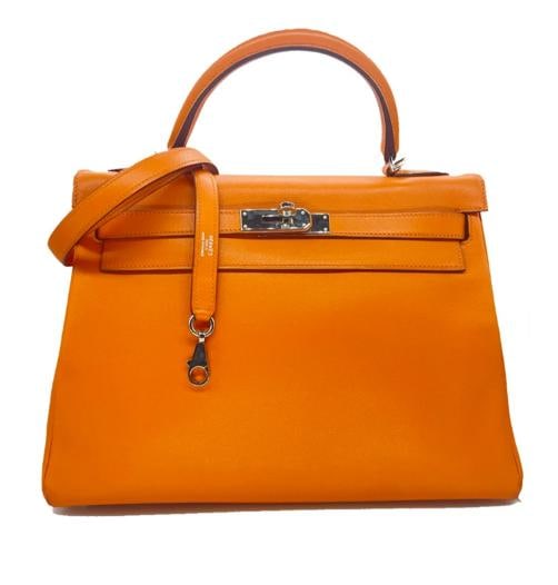 HERMES Kelly Retourne 32 cmm Circa 2005 Orange Veau Swift Palladium Hardware: Condition: Pre-owned - Good: This item has been gently used but is in good condition. It might have a few signs of use, but all imperfections should be shown and described in the seller's listing. ,Ba