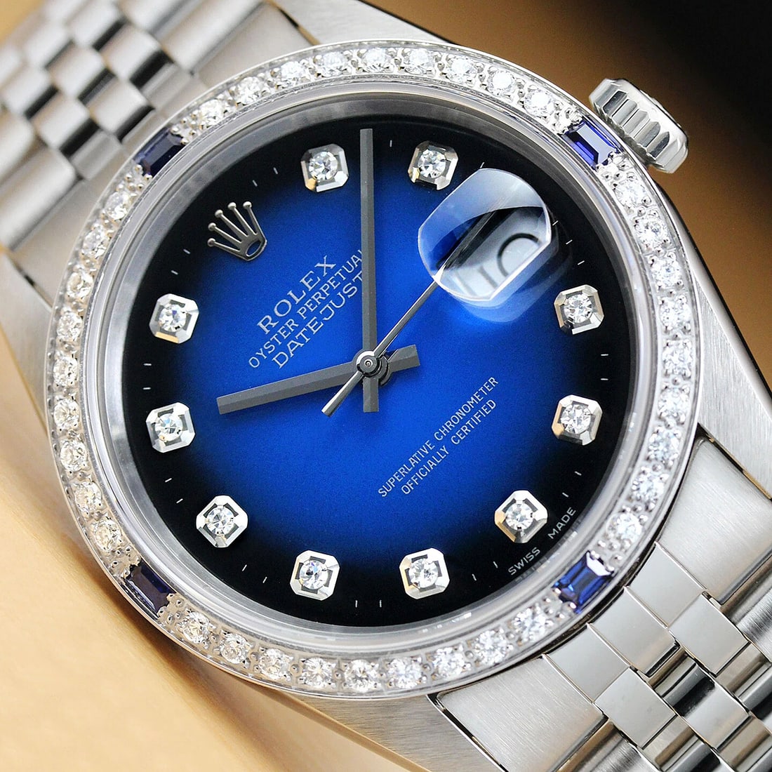 MENS ROLEX DATEJUST 16234 BLUE VIGNETTE 18K WHITE GOLD DIAMOND SAPPHIRE WATCH: This is an authentic Rolex Datejust 16234 watch with Rolex stainless steel jubilee bracelet, Rolex dial Ref. with added custom diamond markers, and custom 18K white gold sapphire diamond bezel. Descri