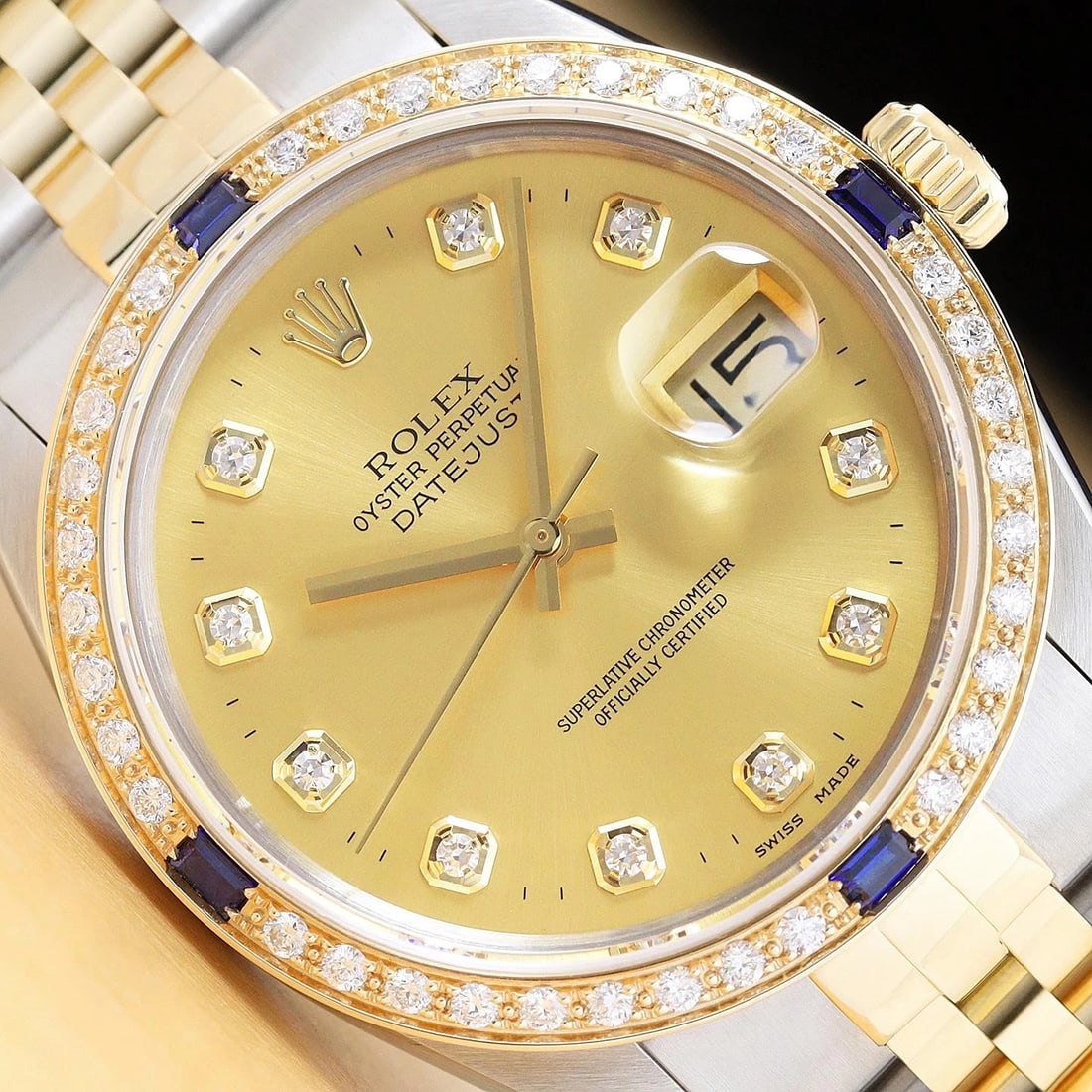 ROLEX DATEJUST 16233 CHAMPAGNE FACTORY DIAMOND SAPPHIRE 18K GOLD STEEL WATCH: This is an authentic Rolex Datejust 16233 watch with a two tone 18K yellow gold and stainless steel jubilee bracelet, factory Rolex diamond dial Ref., and custom 18K yellow gold diamond and sapphire b