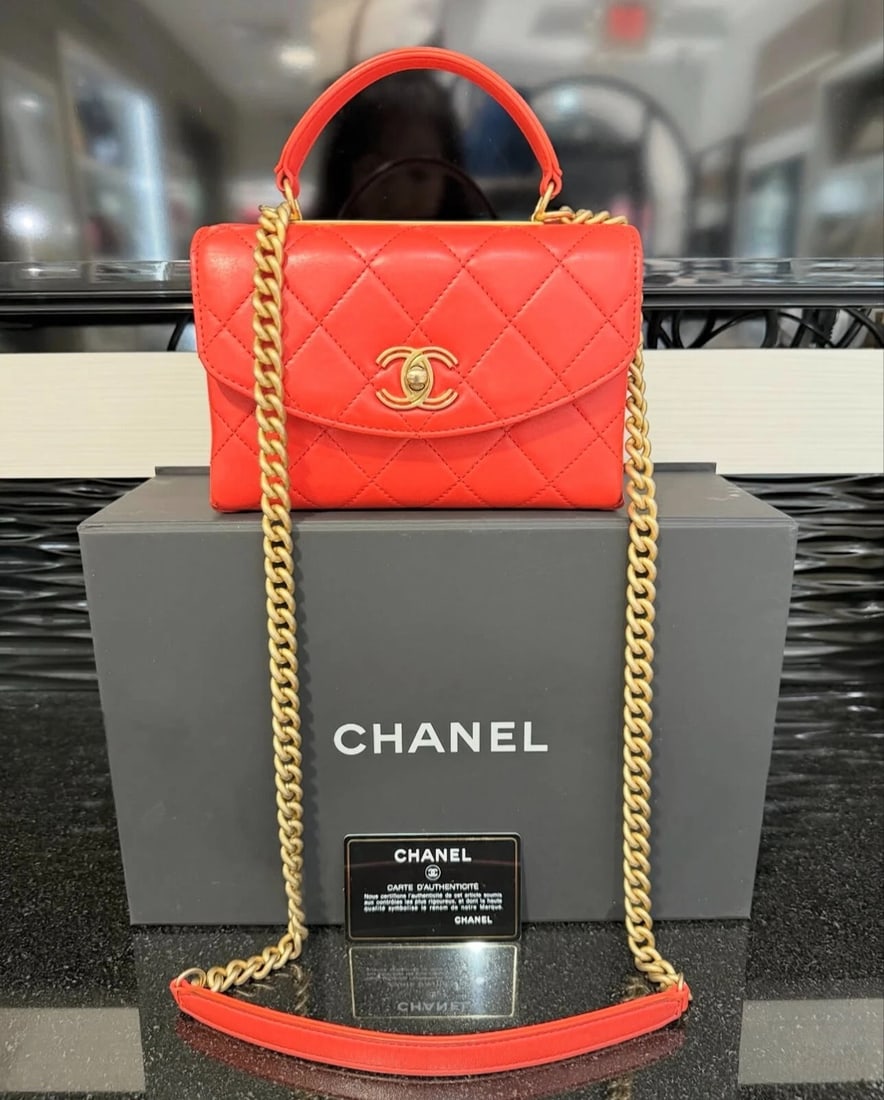 Chanel Spirit Top Handle Bag – Coral Red Lambskin (2018-2019): Condition: Pre-owned - Good,Brand: CHANEL,Department: Women,Character: Spirit,Handle/Strap Color: Orange,Size: Mini,Lining Material: Lambskin,Lining Color: Orange,Hardware Color: Red,Exterior Color: