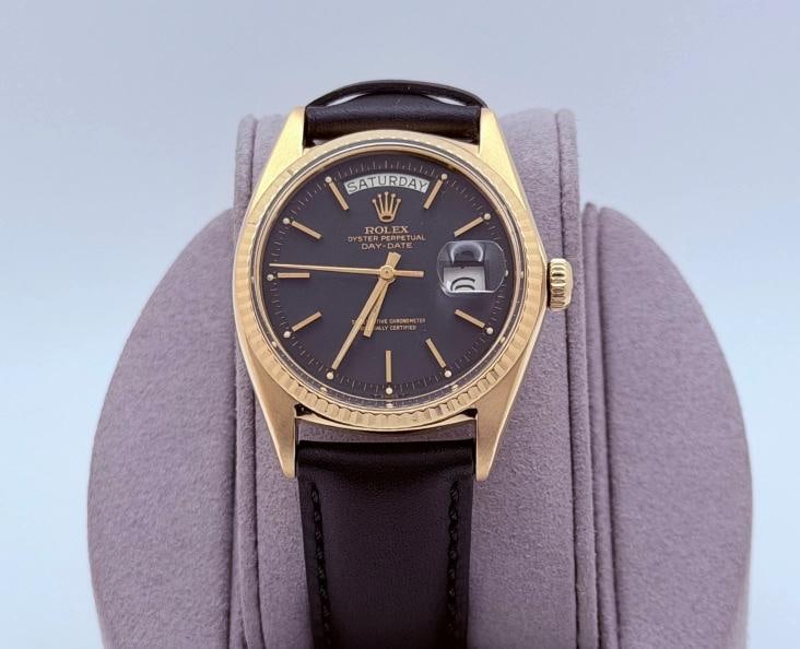 Rolex Day Date 1803 36mm Pie Pan Matte Black Dial 18k Yellow Gold Leather Strap: Style Number: 1803 Serial: 274**** Year: 1971 Model: Rolex Day Date Case Material: 18k Yellow Gold Band: Custom Black Leather Strap with Custom Gold-Plated Buckle Bezel: 18k Yellow Gold Fluted Dial: M