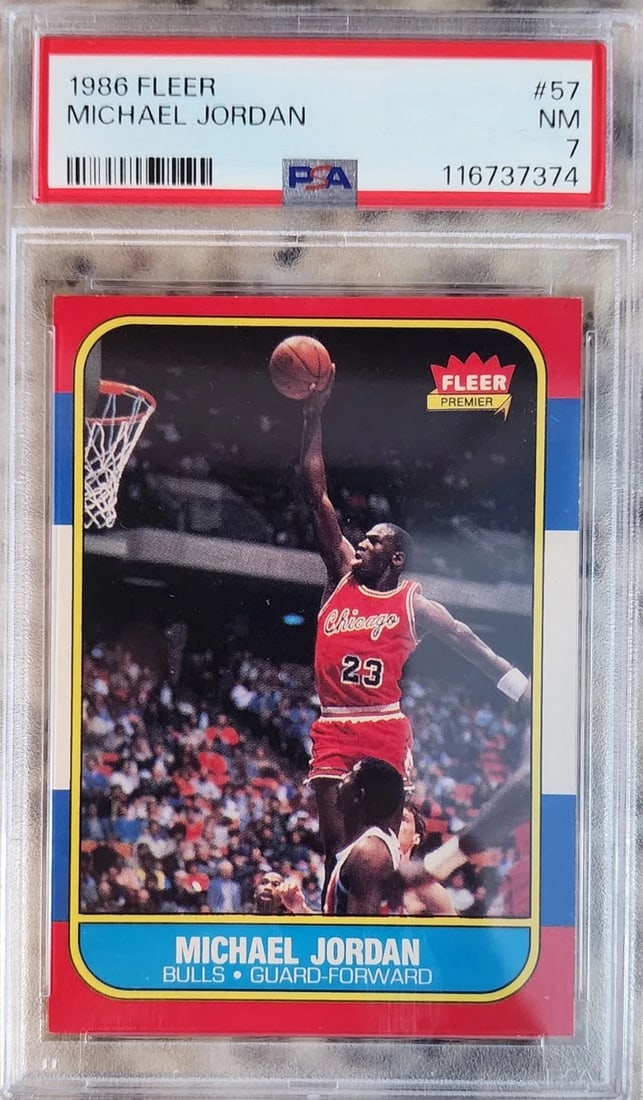Michael Jordan 1986 Fleer #57 ROOKIE CARD (PSA 7): Player: Michael Jordan,Sport: Basketball,Original/Reprint: Original,Autograph Authentication: Professional Sports Authenticator (PSA),Product: Photo,Team: Buffalo Bulls,Country of Origin: United State