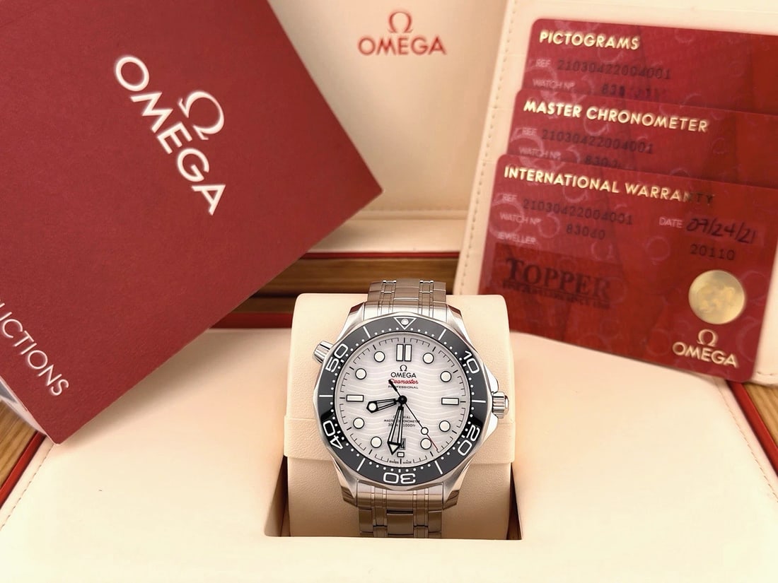 Omega Seamaster Diver 300M 210.30.42.20.04.001 42mm White Dial Steel Box Paper: Style Number: 210.30.42.20.04.001Serial: 8306****Year: 2021 Model: OMEGA Seamaster Diver 300M Case Material: Stainless Steel Band: Stainless Steel Bezel: Black Ceramic Dial: White Ocean Wave Crystal: