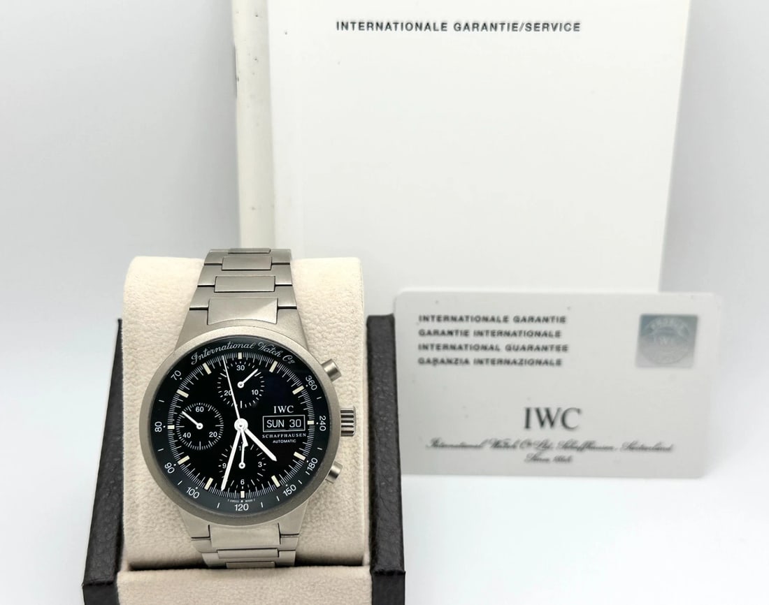 IWC GST Chronograph IW370703 40mm Black Dial Titanium Booklets Paper: Style Number: IW370703Serial: 2750***Year: 2003 Model: IWC GST Chronograph Case Material: Titanium Band: Titanium Bezel: Titanium Dial: Black Crystal: Sapphire Crystal Case Size: 40mm Includes: -IWC W