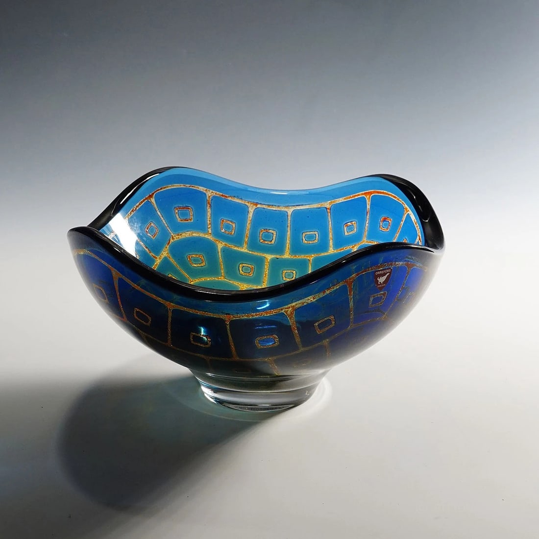 Ravenna Bowl by Sven Palmquist for Orrefors, Sweden 1950s: A heavy bowl of the Ravenna series designed by Sven Palmquist for Orrefors Sweden in the 1950s. The squarish bowl has round undulating edges and is made in blue glass decorated with sandblasted