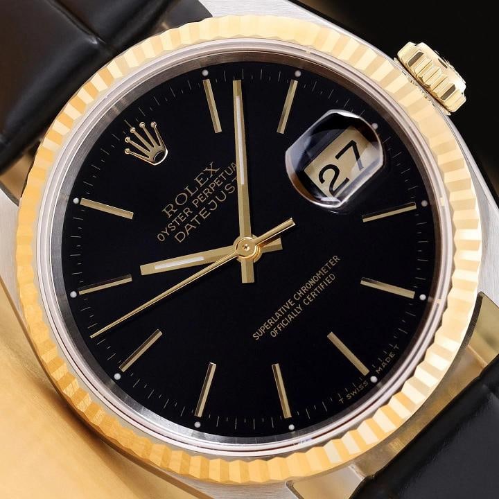 ROLEX MENS DATEJUST 16233 BLACK DIAL 18K YELLOW GOLD STEEL BLACK LEATHER WATCH: This is an authentic Rolex Datejust 16233 watch with Rolex stick dial Ref., Rolex 18K yellow gold fluted bezel, and custom genuine black leather strap. Descriptions: Brand: Rolex Model: Datejust