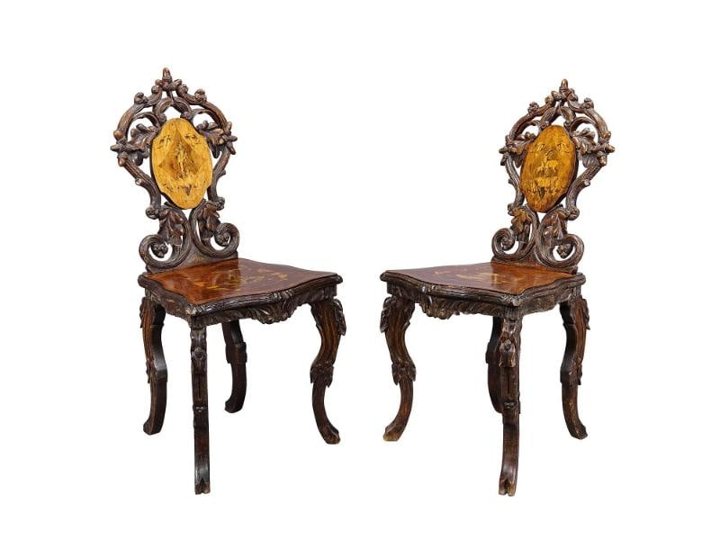 Pair Nutwood Edelweis Marquetry Chairs Swiss Brienz 1900: A pair antique Swiss nutwood chairs decorated with inlayed and painted sceneries depicting goat, ibex, hunter and flowers. Surrounded by ebony and lindenwood marquetry. Manufactured ca. 1900 in Brienz