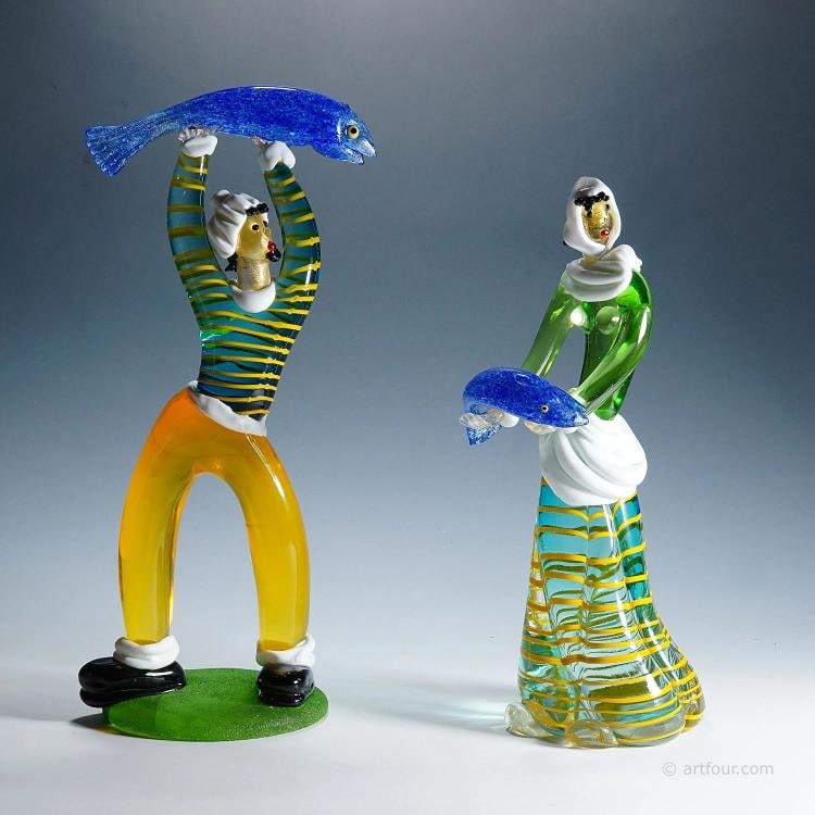 Vintage Murano Glass Sculptures by Anzolo Fuga for A.Ve.M.1950s: A large pair of Murano art glass sculptures depicting a fisherman and a fisherwoman. Designed by Anzolo Fuga and produced by Arte Vetraria Muranese (A.Ve.M.) in the 1950s. Colorless, honey yellow,