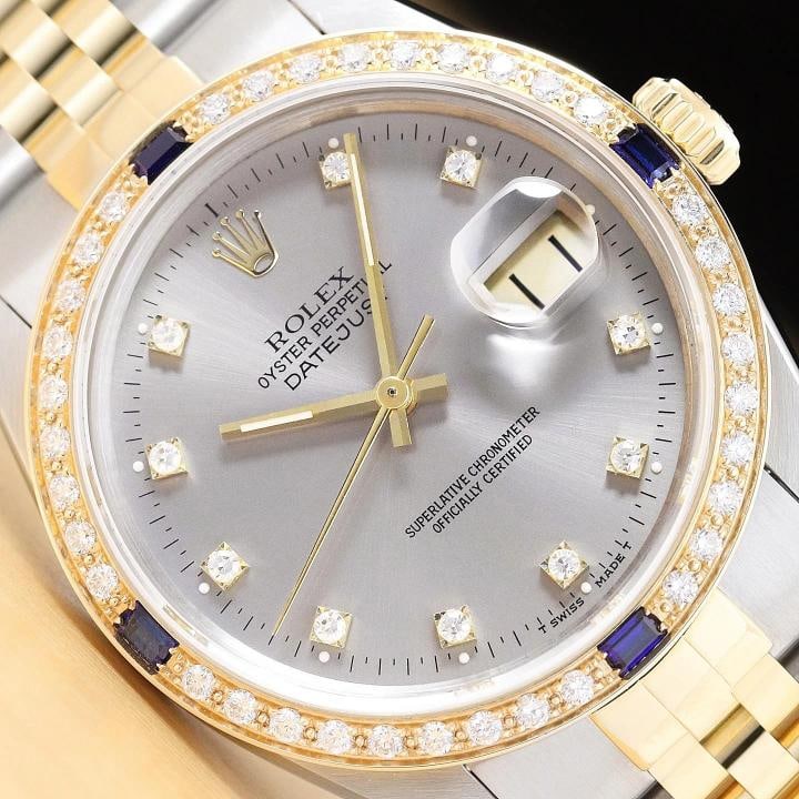 ROLEX DATEJUST 16233 GRAY FACTORY DIAMOND SAPPHIRE 18K YELLOW GOLD STEEL WATCH: This is an authentic Rolex Datejust 16233 watch with a two tone 18K yellow gold and stainless steel jubilee bracelet, factory Rolex diamond dial Ref., and custom 18K yellow gold diamond and sapphire b