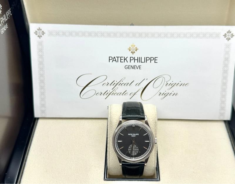 Patek Philippe Calatrava 6119G-001 39mm Charcoal Gray Dial 18K Gold Box Paper: Style Number: 6119G-001 Year: 2022 Model: Patek Philippe Calatrava Case Material: 18K White Gold Band: Leather Bezel: 18K White Gold Dial: Charcoal Gray Crystal: Sapphire Case Size: 39mm Includes: -Pa