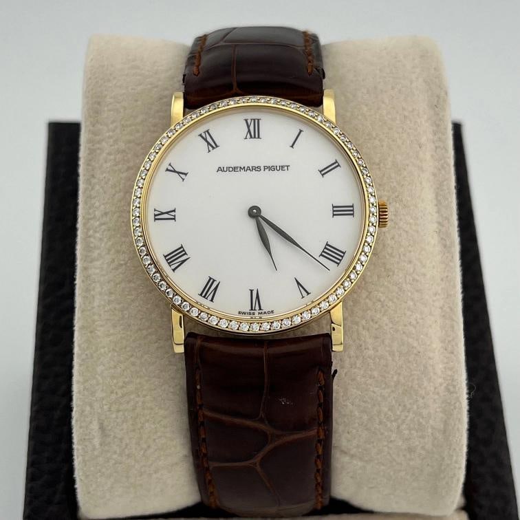 Vintage Audemars Piguet Extra Flat 14273 31mm 18k Gold Factory Diamond Bezel: Style Number 14273 14273BA Serial D13 Model Audemars Piguet Extra Flat Case Material 18k Yellow Gold Band Brown Leather Strap Bezel 18k Yellow Gold With Factory Diamonds Dial White Crystal Sapphire Ca