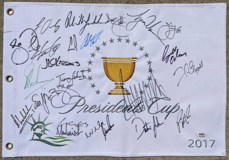2017 Presidents Cup Multi Signed Golf Flag Tiger Woods Donald Trump PSADNA: Signatures include Tiger Woods Donald Trump Phil Mickelson Adam Scott Dustin Johnson Hideki Matsuyama Louis Oosthuizen Jim Furyk Patrick Reed Jason Day Ernie Els Mike Weir Charl Schwarzel plus more Sp