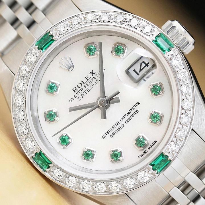 ROLEX LADIES DATEJUST 69174 MOTHER OF PEARL 18K GOLD SS DIAMOND TSAVORITE WATCH: Condition Preowned GoodBezel Color SilverMax Wrist Size 626675 inNumber of Jewels 29 JewelsIndices Tsavorite MarkersBand Rolex Stainless Steel Jubilee BraceletBezel Custom 18K White Gold Diamond and T