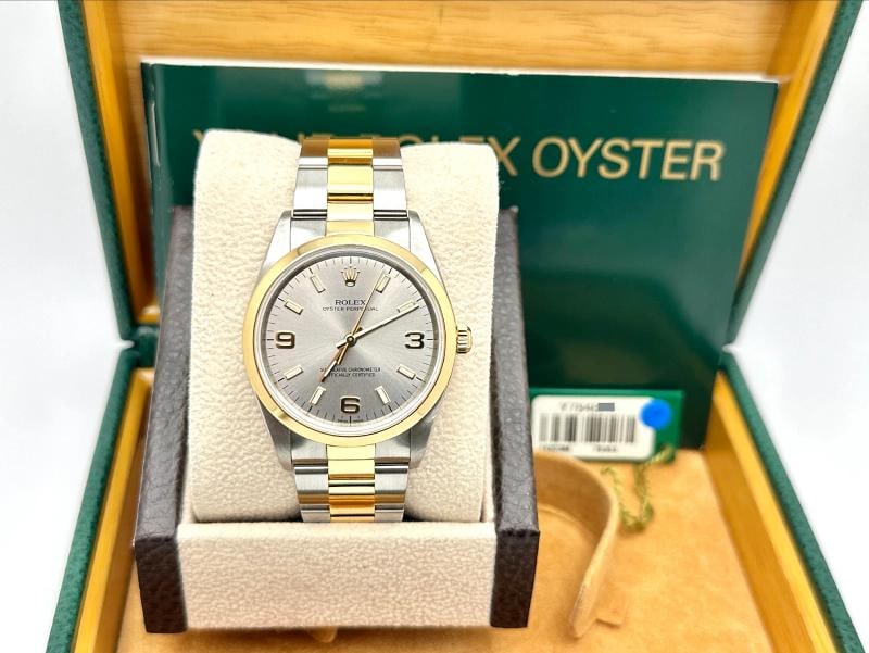 2002 Rolex Oyster Perpetual 14203 34mm Silver Dial 18k Yellow Gold Steel: Style Number: 14203 Serial: Y784*** Year: 2002 Model: Rolex Oyster Perpetual Case Material: Stainless Steel Band: 18K Yellow Gold & Stainless Steel Bezel: 18K Yellow Gold 