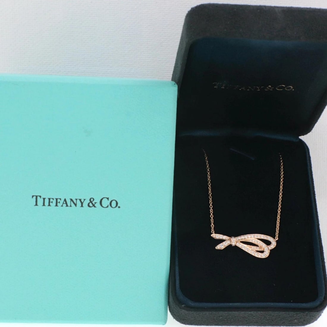 Tiffany & Co. Rose Gold Diamond Bow Pendant 18K: Condition: Pre-owned - Good,Cut: Excellent,Metal: Rose Gold,Clarity: VS1,Main Stone Shape: Round,Modified Item: No,Necklace Length: 16 in,Length: 16 - 17.99",Pendant Shape: Bow,Length (inches): 16'',M