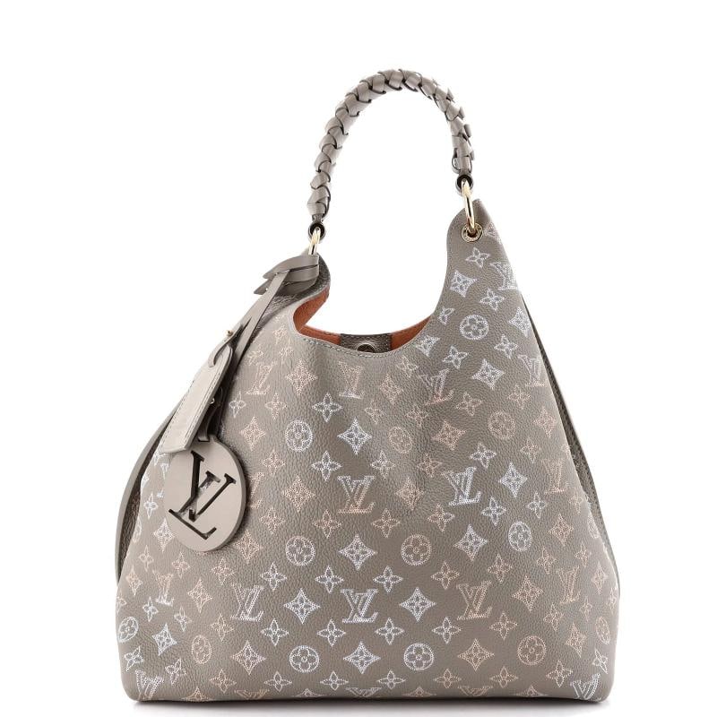 Louis Vuitton Carmel Hobo Flight Mode Mahina Leather: Accessories: Charms, Luggage Tag Measurements: Handle Drop 10.5", Height 12", Width 13.5", Depth 7", Strap Drop None". Condition: Pre-owned - Good,Brand: Louis Vuitton,Exterior Material: Leather,Style