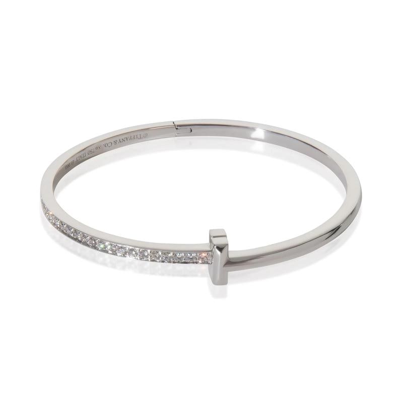 Tiffany & Co. White Gold Diamond Tiffany T T1 Narrow Hinged Bracelet: Condition: Pre-owned,Shape: Round Brilliant,Item Length: 6.5 in,Country of Origin: Italy,Clasp/Buckle Type: Pusher,With Original Box/Packaging: Yes,Side Stone Type: Diamond,Side Stone Weight (cts):