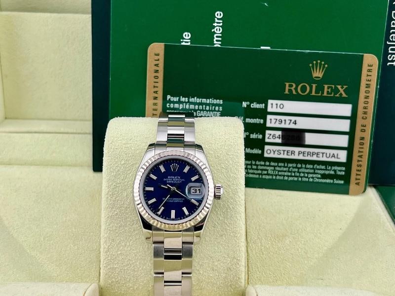 Rolex Datejust Ladies 179174 Blue Dial Stainless Steel 18K Gold Bezel Box Paper: Condition: Pre-owned - Good,Country of Origin: Switzerland,Bezel Color: Silver,Year Manufactured: 2010-2019,Band/Strap: Rolex Oyster,Case Color: Silver,Department: Women,Bezel Type: Fluted,Watch