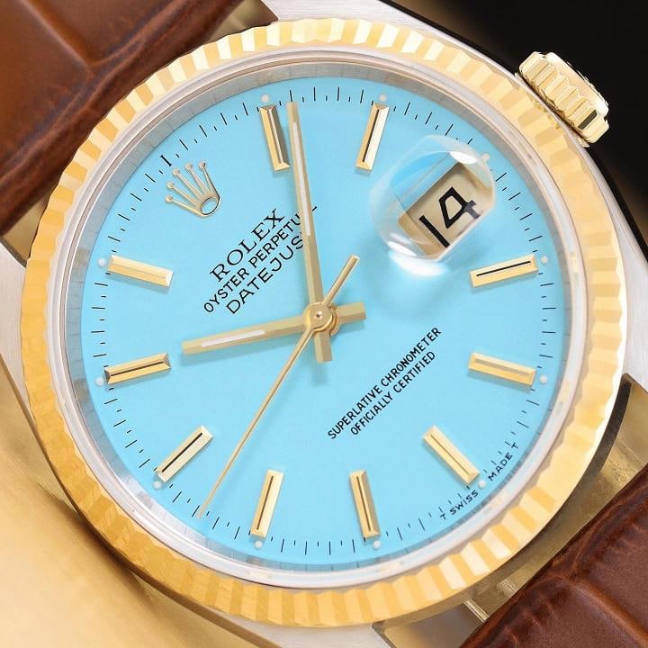 ROLEX MENS DATEJUST 16233 AQUA BLUE DIAL 18K GOLD STEEL WATCH w/ LEATHER BAND: This is an authentic Rolex Datejust 16233 watch with Rolex stick dial Ref., Rolex 18K yellow gold fluted bezel, and custom genuine brown leather strap. Descriptions: Brand: Rolex Model: Datejust Refer