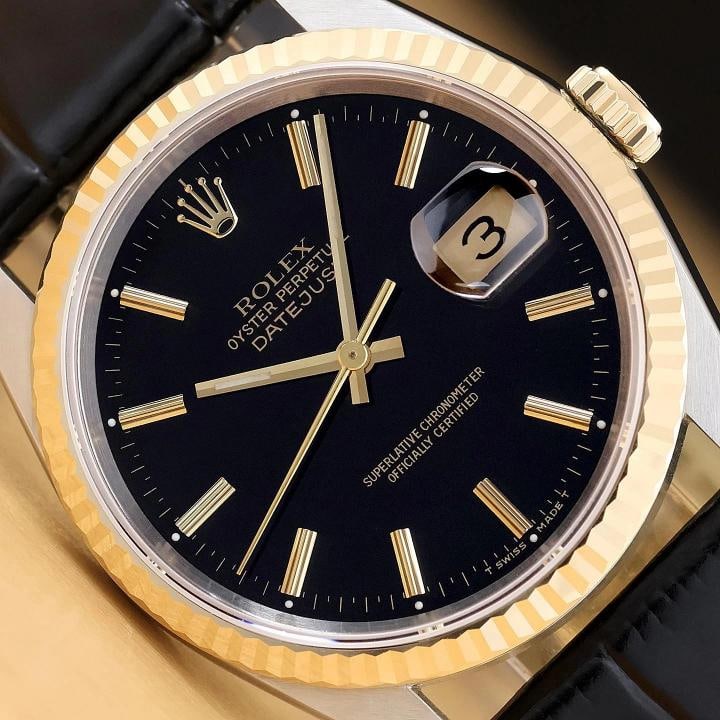 ROLEX MENS DATEJUST 16233 BLACK DIAL 18K YELLOW GOLD STEEL BLACK LEATHER WATCH: This is an authentic Rolex Datejust 16233 watch with Rolex stick dial Ref., Rolex 18K yellow gold fluted bezel, and custom genuine black leather strap. Descriptions: Brand: Rolex Model: Datejust Refer