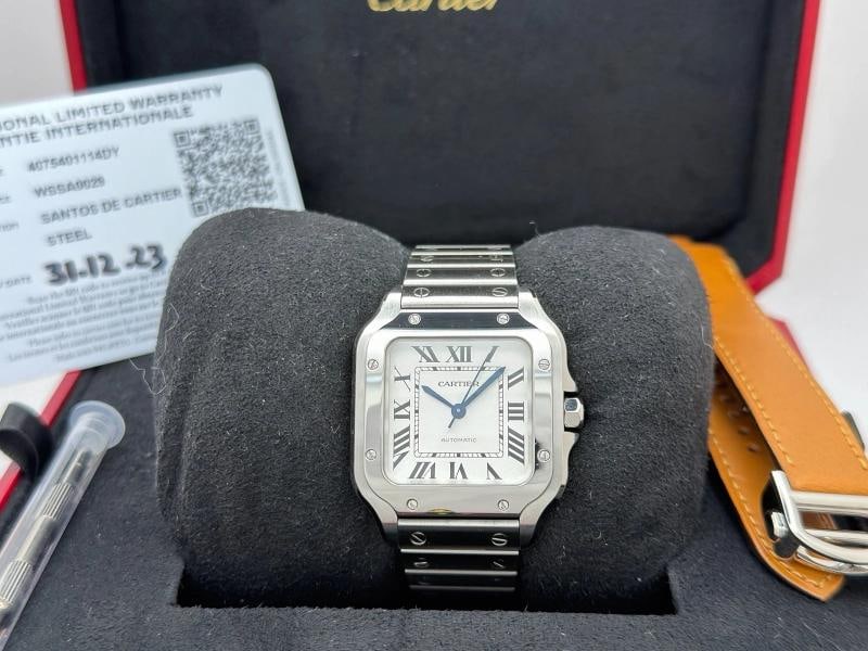 2023 Cartier Santos Medium WSSA0029 4075 35.1 mm Silver Dial Steel Box Papers: Style Number: WSSA0029 / 4075 Year: 2023 Model: Cartier Santos Medium Case Material: Stainless Steel Band: Stainless Steel Bracelet (Comes with Additional Factory Leather Strap) Bezel: Stainless Steel