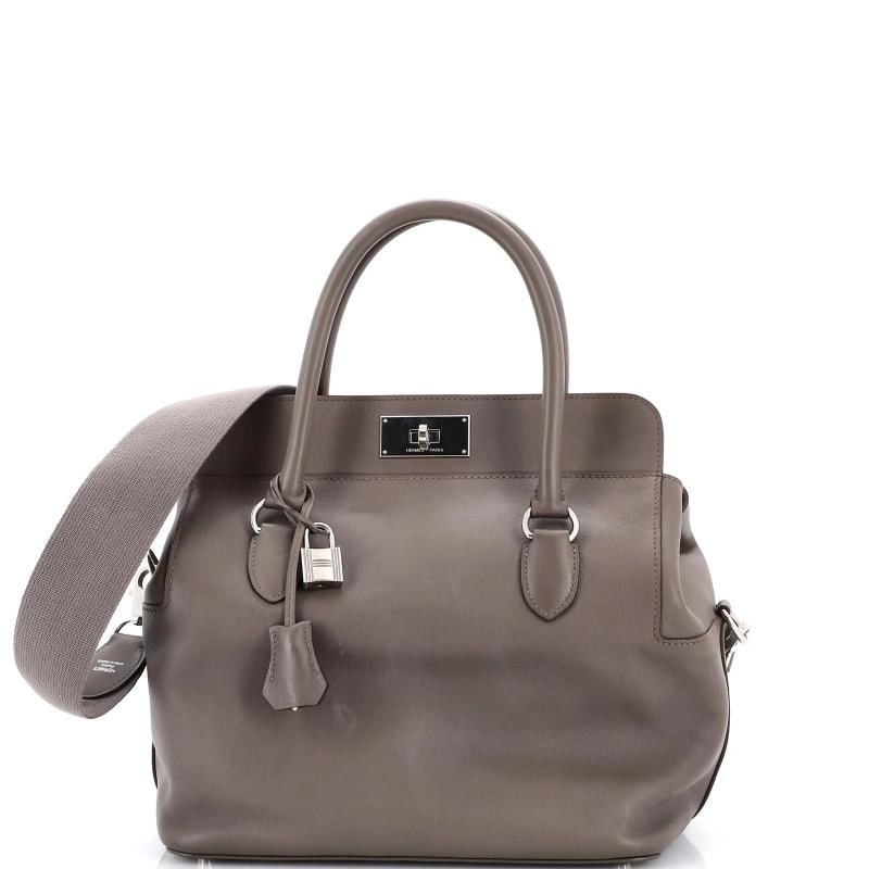 Hermes Toolbox Bag Swift 26: Accessories: Keys, Clochette, Lock, With Strap Measurements: Handle Drop 3.5", Height 10", Width 10", Depth 7", Strap Drop 10.5". Condition: Pre-owned - Fair,Brand: Hermes,Exterior Material: Leather,S